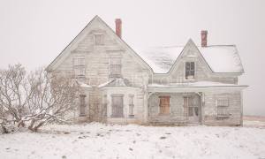 White house in the snow in Advocate Harbour, NS.